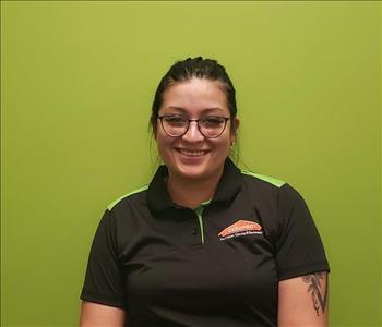 Woman on a green background in SERVPRO shirt