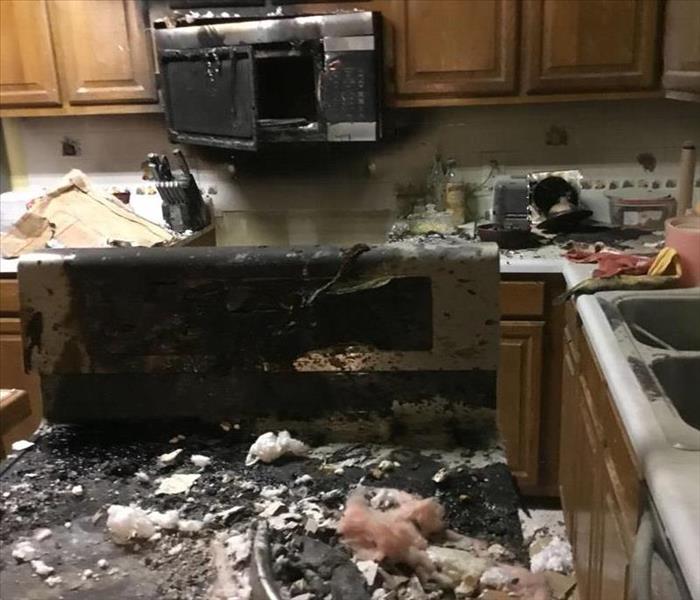 Kitchen with fire damage throughout