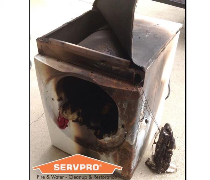Burned clothing dryer with SERVPRO logo